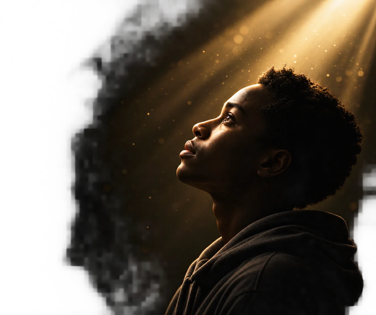 A young man turns his gaze toward warm, radiant light